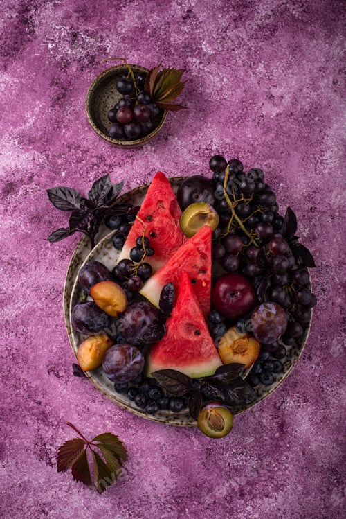 Preview: Assortment of purple fruit plum, grape, blueberry and basil