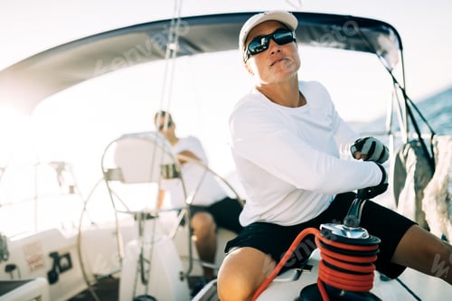 Preview: Attractive strong woman sailing with her boat