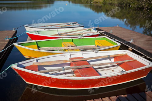 Preview: Floating Color Wooden Boats with Paddles in a Lake