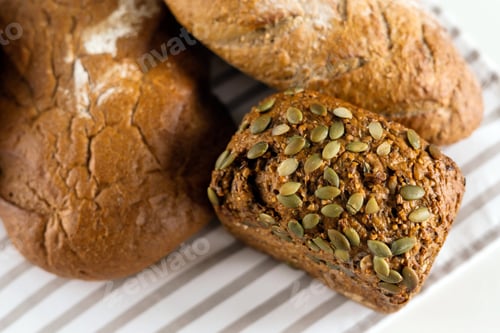 Preview: Delicious fresh bread lies on the breakfast table on a white table.