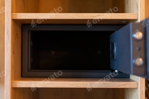 Preview: A lockable safe is positioned in an open wooden cabinet, showcasing its depth and design