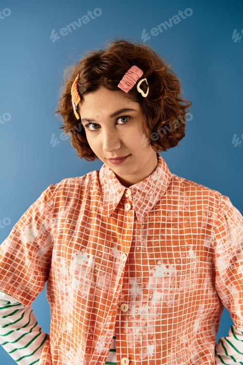 Preview: Vibrant summer fashion portrait of a young woman with curly hair against a blue backdrop