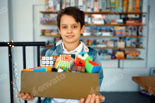 Preview: Little boy holds box of different puzzle cubes