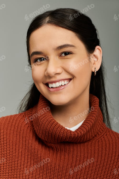 Preview: Young emotional woman in stylish attire radiating joy in a cozy, intimate setting