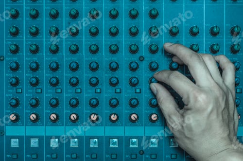 Preview: Top view of Hand adjusting audio mixer, music instrument concept