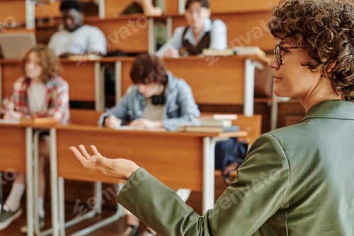 Preview: Side view of young confident coach explaining new subject to group of students