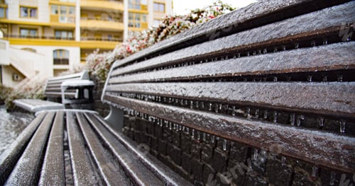 Preview: Frozen city bench in the ice icicles. City environment in a winter.