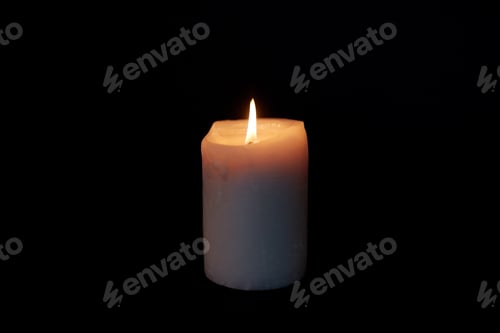 Preview: candle burning in darkness over black background