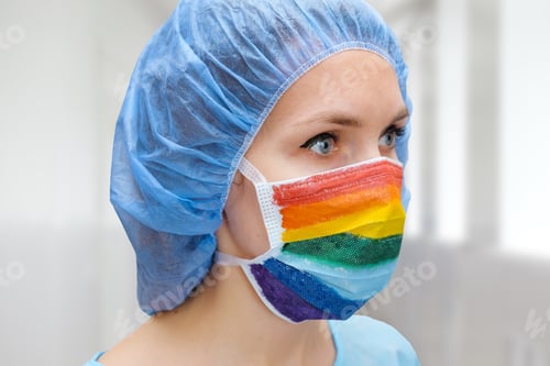 Preview: Portrait Of A Doctor In A Mask, On Which A Rainbow Is Drawn As A Sign Of Hope Of Victory Over A