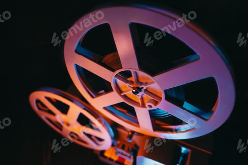 Preview: Film reels turning. Analog player, cans with tape. Retro old-fashioned 8mm projector playing movie