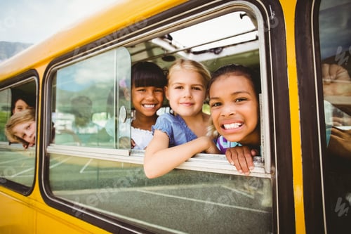 Preview: Cute Pupils Smiling At Camera In The School Bus Outside The Elementary School