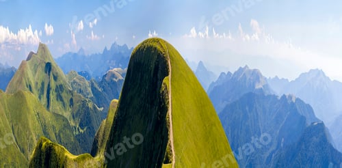 Preview: Panorama of green hills in summer mountains with gravel road for travelling by car