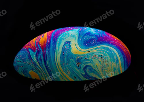 Preview: Close-up shot of a rainbow soap bubble in a dark background.