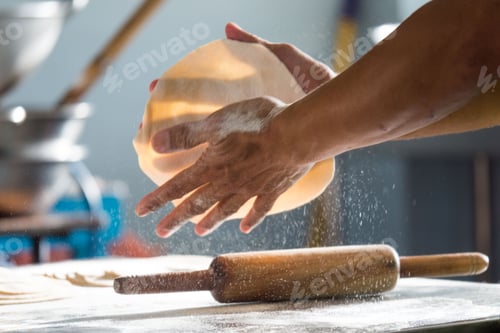 Preview: Closeup shot of a man making roti flatbread in a kitchen