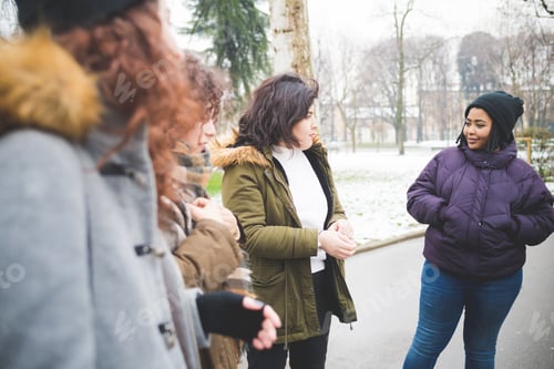 Preview: group of young multiracial women having talk in the street