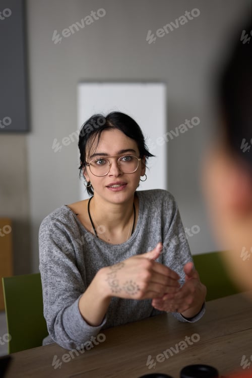 Preview: A close up portrait of a young businesswoman engaged in a professional meeting, confidently