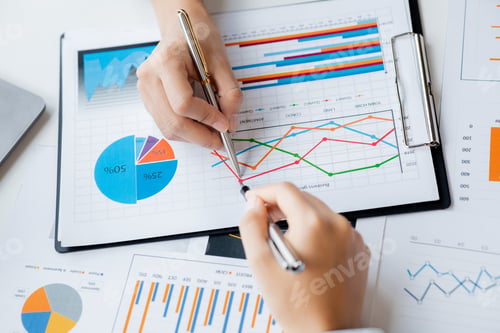 Preview: Two businessmen pointed to the material for the meeting.
