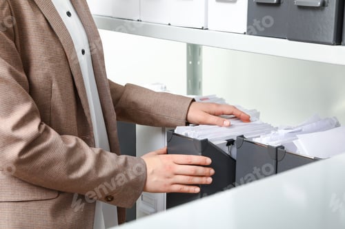 Preview: Woman taking documents from folder in archive, closeup