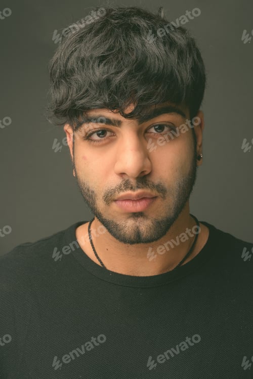 Preview: Young handsome Indian man against gray background