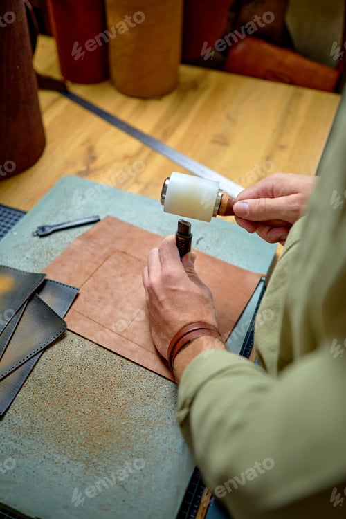 Preview: Sewing process of the leather belt. Man's hands behind sewing. Leather workshop.