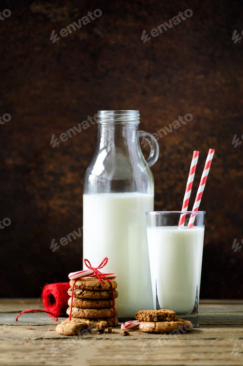 Preview: Christmas dark background with snow and bokeh, copy space. Bottle, glass with milk for Santa