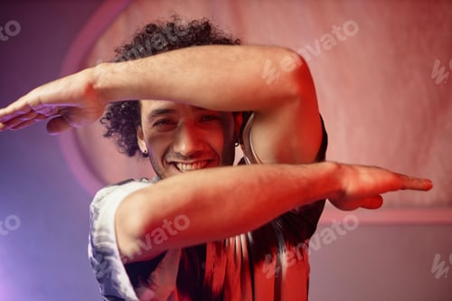 Preview: Cheerful Man Posing with Arms in Front of Face