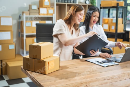 Preview: Two Asian business woman work at desk,selling fashion clothes online.They packing checking items