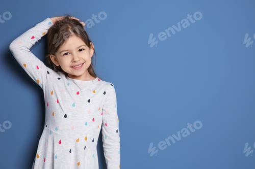 Preview: Little girl measuring her height on color background