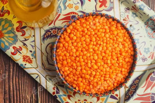 Preview: Bowl of orange lentils on a decorative tray
