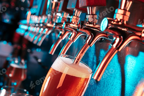Preview: Hand of bartender pouring a large lager beer in tap