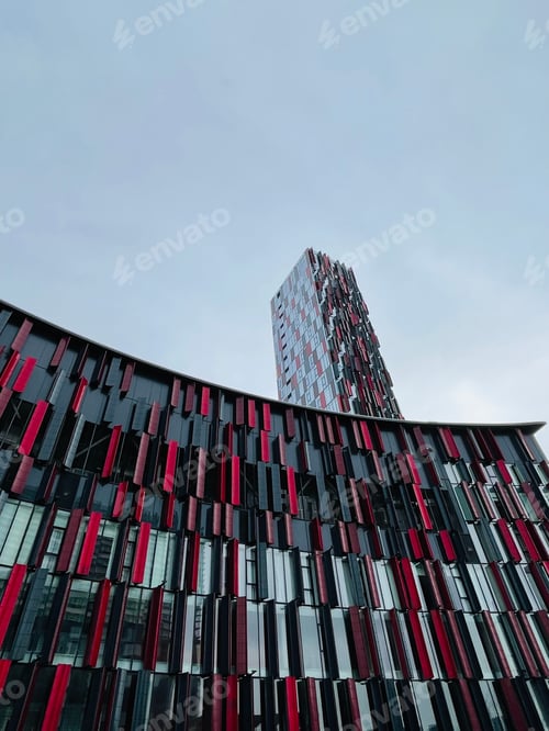 Preview: looking up at a colorful building with a tall building in the background