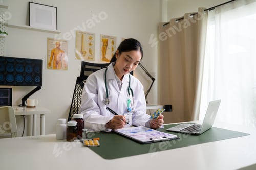 Preview: Asian female doctor working in clinic office holding pills