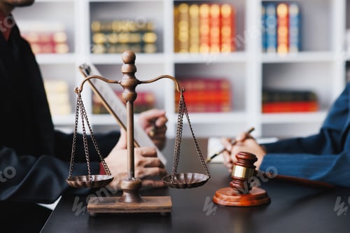 Preview: Lawyer working with client discussing contract papers with brass scale about legal legislation.