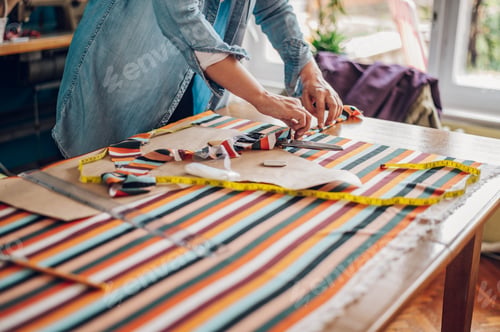 Preview: Woman tailor hands working from home and tailoring beautiful clothes