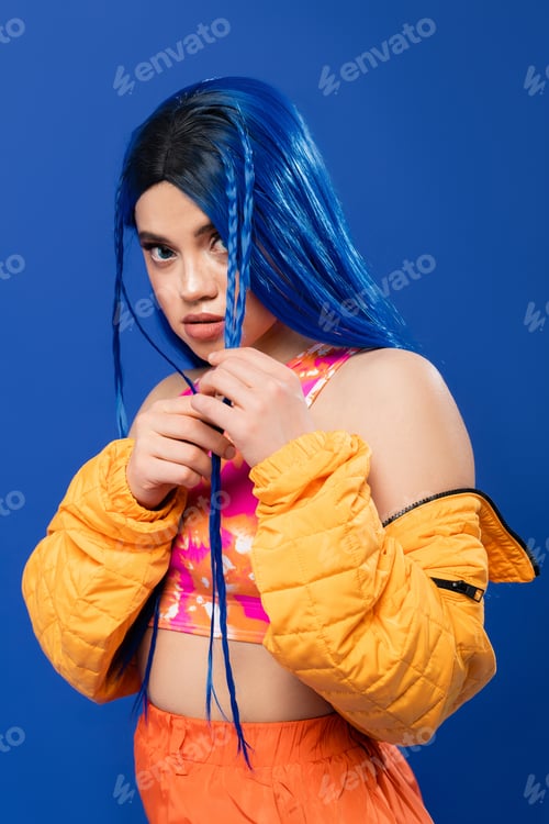 Preview: colorful clothes, young woman with dyed hair posing in puffer jacket
