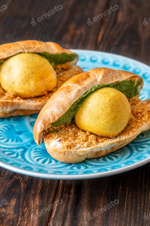 Preview: Authentic Vada Pav Indian street food with spicy chutney on rustic wooden background