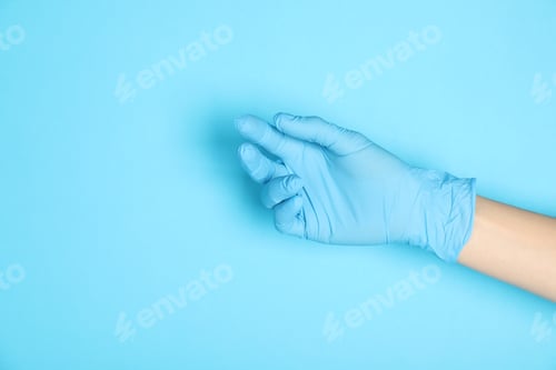 Preview: Hand Wearing Blue Glove on Light Blue Background