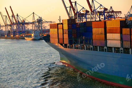 Preview: Cargo ship loaded with containers at sunset in a bustling port
