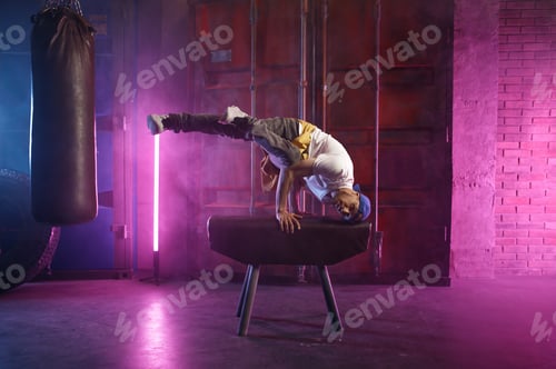 Preview: Male hip hop dancer on head stand doing acrobatic stunt
