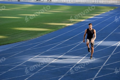 Preview: fast handsome runner exercising on running track at stadium