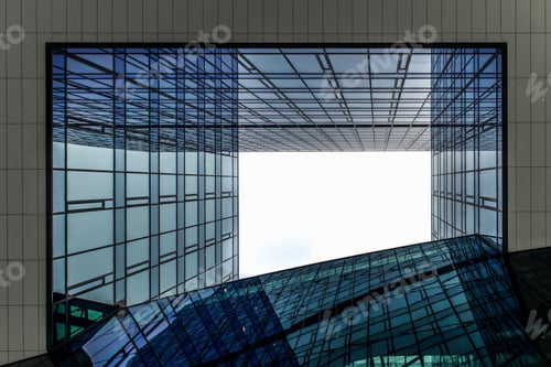 Preview: Low angle shot from the center of buildings with windows reflecting the blue sky