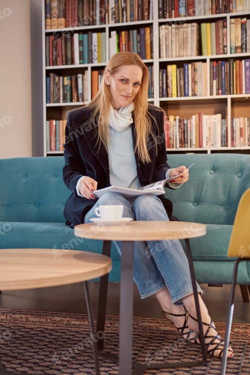 Preview: One Woman Sitting, 40 Years Old, Holding Magazine, Book Shop, Book Store, Books On Shelf Behind