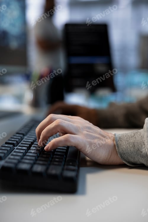 Preview: Close up of data center worker conducting security audits, typing on keyboard