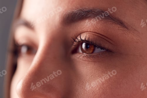 Preview: Close Up On Eyes Of Smiling Young Woman Shot Full Frame In Studio