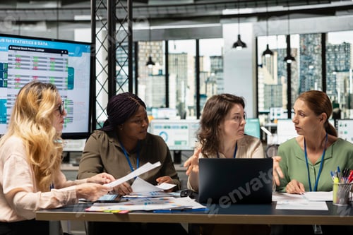 Preview: Ambitious and goals oriented staff members reviewing corporate reports and graphs