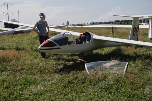 Preview: Mature glider pilot in the airplane before flight in fixed-wing plane