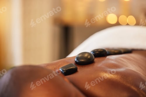 Preview: Back, man and hot stone massage in a beauty spa for muscle relaxation and health or wellness. Bodyc
