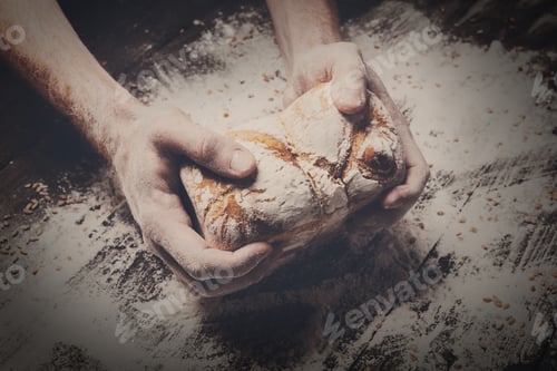 Preview: Bakery concept background. Hands hold bread loaf
