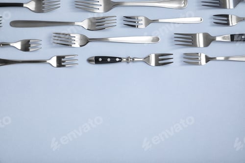 Preview: Set of different metal forks on white background, top view