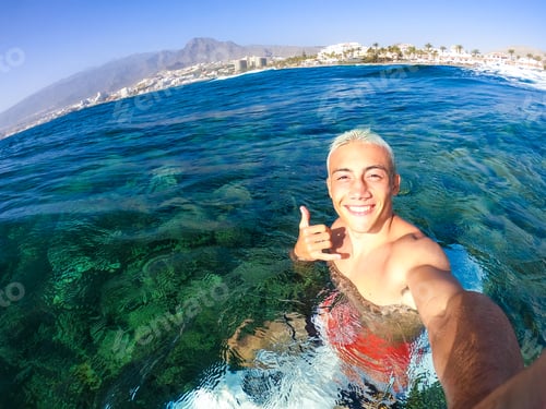 Preview: one teenager man enjoying surfing lifestyle at the beach in the sea or ocean